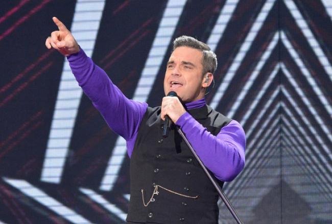 Robbie Williams performing on X Factor