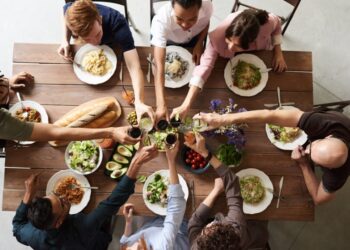 A group of people sharing food at a table.